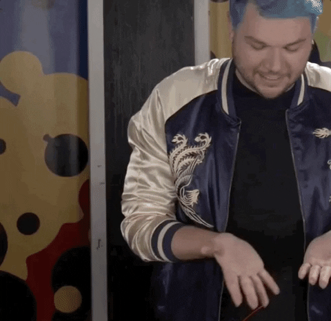 Woman holding glue gun, man in background