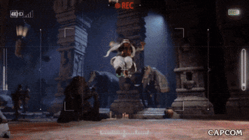 Video game gif. Recorded video footage of Rashid from "Street Fighter 6" doing a running somersault, landing in a deep lunch and pointing at the camera before running back. 