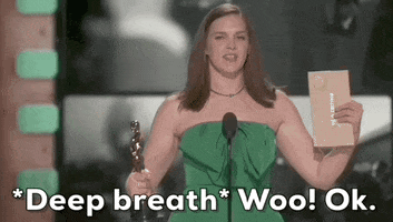 Oscars 2024 gif. Jennifer Lame wins Best Editing for Oppenheimer. She closes her eyes and lets out a quick exhale to regain her composure before smiling at the crowd. Text reads, "*Deep breath* Woo! Ok."
