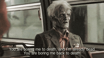 Video gif. Zombie with grayed, rotting skin, white hair, and a white eyes turns to someone as he rides the bus and says, “You are boring me to death, and I’m already dead. You are boring me back to death.”
