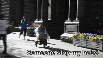 Video gif. Man chases a baby stroller that is rolling down the sidewalk. He yells, “Someone stop my bay!” Suddenly someone jump and drop kicks the stroller, causing the baby to fly out.