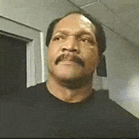 Video gif. A man with a moustache looks angry offscreen and shouts: Text, Damn!