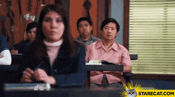 TV gif. Ken Jeong as Ben in Community places his hands to the side of his mouth and yells from the back of a classroom. Large text scrolls across the screen, "Ha! Gay"