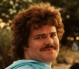 Movie gif. Jack Black as Ignacio in Nacho Libre looks towards the camera with a small, tight grin, and then looks away awkwardly, pressing his lips against his teeth. 