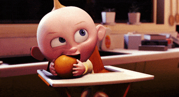 Disney gif. Jack-Jack from The Incredibles sitting in a high-chair, gnawing on an orange.