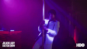 TV gif. Tommy Davidson in character on the Black Lady Sketch Show, dressed in a powder-blue suit, thrusting on a pole in the club.