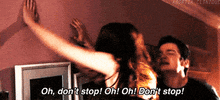 Movie gif. Dan Byrd as Brandon in Easy A jumps up in down and slaps the wall, playing along with Emma Stone as Olive who slaps a wall while shouting, "Oh, don't stop! Oh! Oh! Don't stop!"
