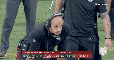 Sports gif. Robert Saleh, head coach of the New York Jets, is leaning forward with his hands on his thighs and he blows air out of his mouth before hanging his head.