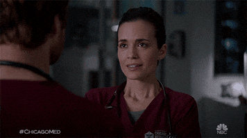 TV gif. Torrey DeVitto as Natalie in Chicago Med rushes toward Nick Gehlfuss as Will before they embrace each other tenderly.