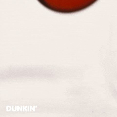 Sponsored gif. Waterfall of Dunkin’ Donuts coffee splashes onto a flat surface. Text reads, “Need coffee.”