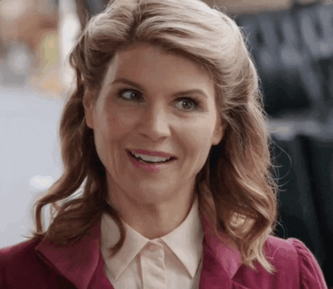 TV gif. Lori Loughlin as Abigail Stanton on When Calls the Heart has a big confident smile on her face and holds two tightly crossed fingers for good luck. 
