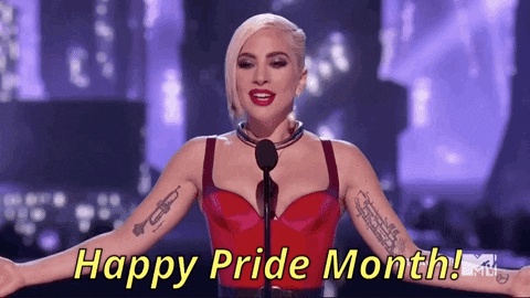 A GIF of Lady Gaga standing at a microphone with her arms held out while saying 'Happy Pride Month!'