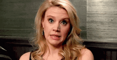 Celebrity gif. Kate McKinnon winces an exaggerated frown as her head lowers in a cringe. 