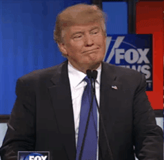Political gif. Donald Trump on Fox News stands at a microphone and has his mouth closed with a firm chin. He holds up a finger, adjusts the microphone, and shakes his shoulders, blinking. 