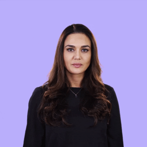 Celebrity gif. Preity Zinta's mouth opens and her eyes widen. She puts an open palm to her face. Animated purple shapes radiate from her.