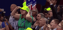 Political gif. A woman at the Republican National Convention stands on a chair and boos, lifting her hands in the air to put both thumbs down. 