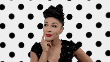 Celebrity gif. In a glittery black dress, Crystal Starr stands in front of a white backdrop with black polka dots. She taps her finger against her chin as if she's thinking before looking at us and shaking her head no.