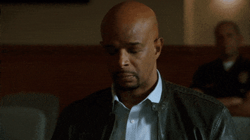 TV gif. Damon Wayans as Roger in Lethal Weapon leans forward and puts his face in his hands as he tensely rubs his forehead.