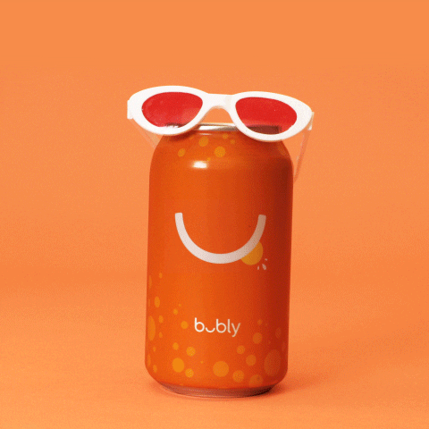 Video gif. A pair of white-rimmed sunglasses with red lenses sits on top of a can of Bubly. The sunglasses slide down onto the side of the can, making the curved logo look like a smile. Text, "Cool."