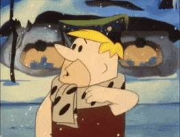 TV gif. Barney Rubble from Flintstones stares off confused in the snow as he scratches the top of his head.