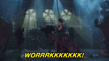 Musical gif. Mary J. Blige as the Wicked Witch of the West in The Wiz Live! runs to the center of the stage with blue lights beaming down upon her. She wears a gothic, jet black dress with a shimmering, magenta hem and stares theatrically at the crowd while background dancers move in sync behind her. Text reads, "WORRRKKKKKKK!"