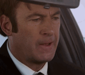 TV gif. Bob Odenkirk as Saul in Better Call Saul. He's sitting in his car and it's a close up on his face. He's breathing heavily and he suddenly scrunches his whole face and bites his lip in anger, looking like he's squeezing something very hard out of frustration.