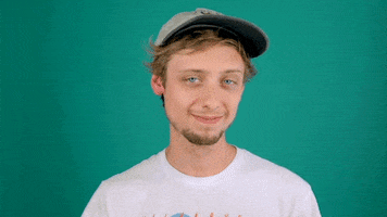 Video gif. A man holds up a pot of coffee and looks at us with a smile. 