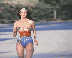 TV gif. Lynda Carter as Wonder Woman runs toward us in slow motion.
