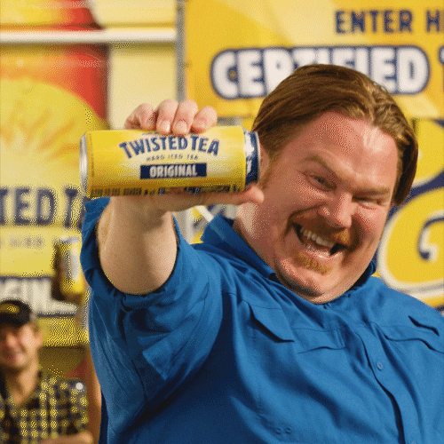 Ad gif. Casey Webb holds up a big can of Twisted Tea towards us with a big smile and points at it.