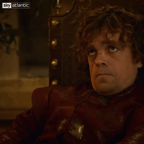 TV gif. Peter Dinklage as Tyrion in Game of Thrones raises a chalice as he gazes up disinterestedly.