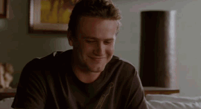 Movie gif. Jason Segel as Peter in Forgetting Sarah Marshall shrugs with his palms up and an innocent smirk on his face. 
