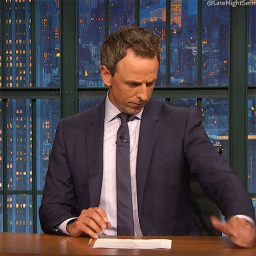 Late Night gif. Seth pretends to scroll through an invisible phone, then reacts with an exaggerated "uh oh" look.