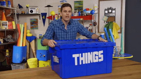 Gif of a man opening a large blue box with 'things' written on the side