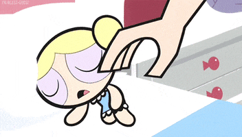 Cartoon gif. Hand places an octopus stuffed animal in the arms of a sleeping Bubbles from The Powerpuff Girls. Without waking up, she hugs the octopus tightly and smiles contentedly.