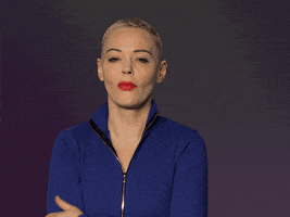 Celebrity gif. Rose Mcgowan rolls her eyes and holds her hand up as she mockling yawns. She then looks straight at us with an annoyed expression and crosses her arms. 