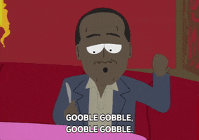 Cartoon gif. OJ Simpson on South Park sits in a restaurant booth while looking down at a butter knife in his hand. He dances side to side in his seat as he says, “Gooble gobble, gooble gobble.”