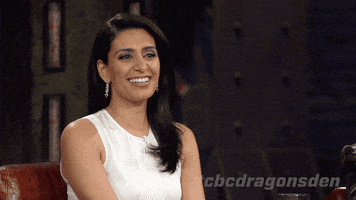 Reality TV gif. Manjit Minhas, a judge on Dragon's Den, is cracking up and she closes her eyes and tosses her head back as she laughs.