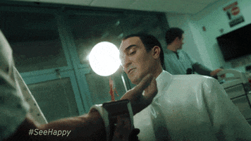 TV gif. In a clip from Happy, a doctor is splashed in the face by a stream of blood from a patient's wrist.