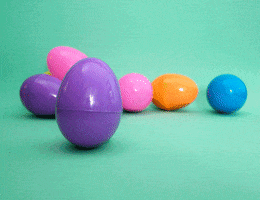 Digital compilation gif. Purple plastic Easter Egg rocks around then cracks open on a pale green surface. Five crocheted bunnies hop out, each a different color.
