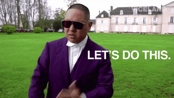 TV gif. Eddie Huang from Huang's World stands on a grass lawn in front of a mansion, wearing a purple suit and sunglasses. Text, "Let's do this."