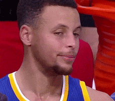 Sports gif. Steph Curry from The Golden State Warriors is sitting on the bench looking incredibly peeved. His mouth is in a grim line and he tightens his jaw as he shakes his head in disapproval while looking away.