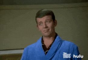 TV gif. Robert Reed as Mike from the Brady Bunch. He gives a knowing look while shooting us an OK hand symbol before breaking into a smile. He looks proud, as if a job has been well done. 