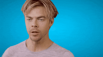 Celebrity gif. Dancer and actor Derek Hough spins around quickly, his hair flopping around, before staring into our eyes and pointing at us. 