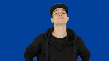 Celebrity gif. Brendon Urie looks at us with a smug smirk on his face as he nods. He has his hands confidently on his hips.