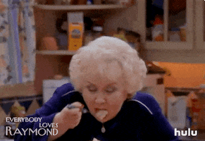 TV gif. Doris Roberts as Marie Barone on Everybody Loves Raymond holds a bowl full of what looks like mash potatoes. She leans down and tastes a forkful of it. She closes her eyes and puts a hand on her chest as if this is the best dish she’s ever tasted. 