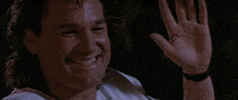 Movie gif. Sylvester Stallone as Tango and Kurt Russell as Cash from Tango and Cash smile at each other and high five.