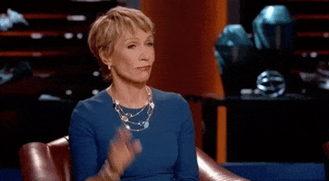 TV gif. Barbara Corcoran of Shark Tank raises a hand to ask a question.