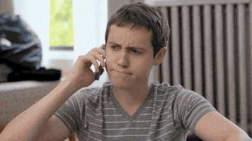 goodworker phone annoyed listening eyebrows GIF