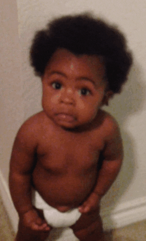 Video gif. A toddler juts out his chin as he tenses his whole body and looks up with wide eyes.