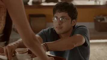indian male taking chai cup off a tray